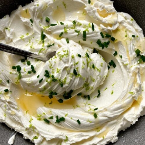A creamy dip made from whipped feta, drizzled with honey and garnished with lime zest and chives.